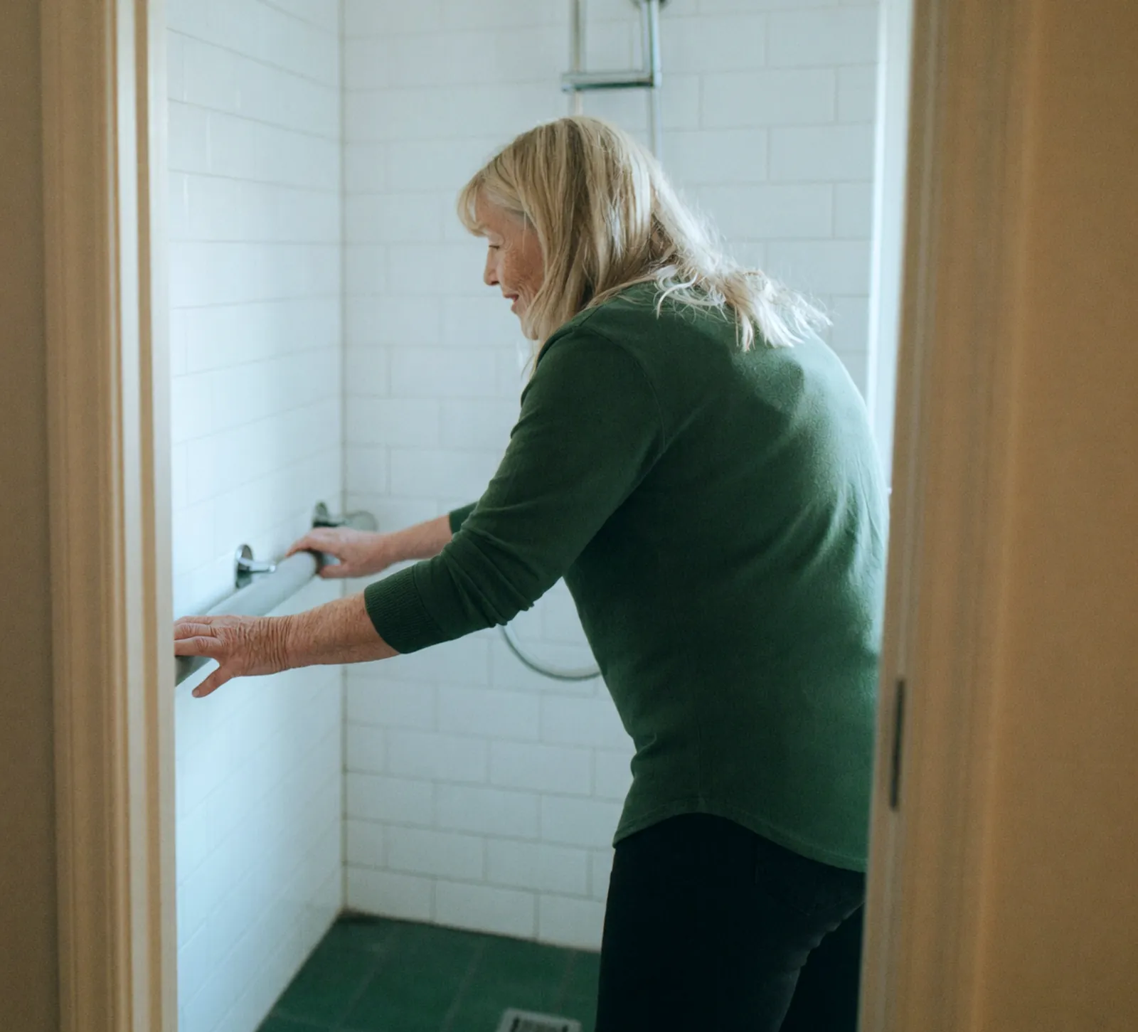 An occupational therapist testing a bathroom shower fixture