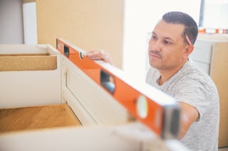 Contractor installing modified cabinets